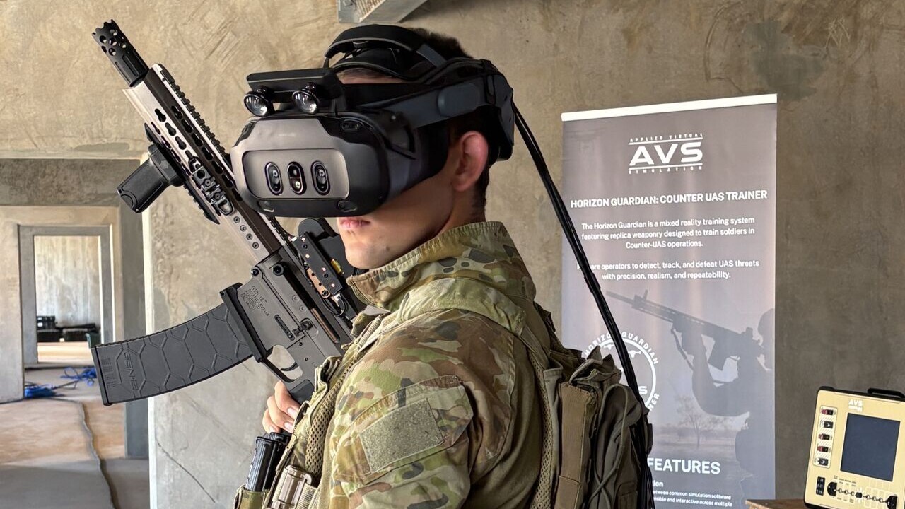 A person dressed in a combat uniform wearing a virtual reality headset