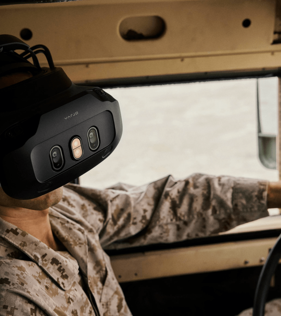 a person sitting in a vehicle wearing an XR headset