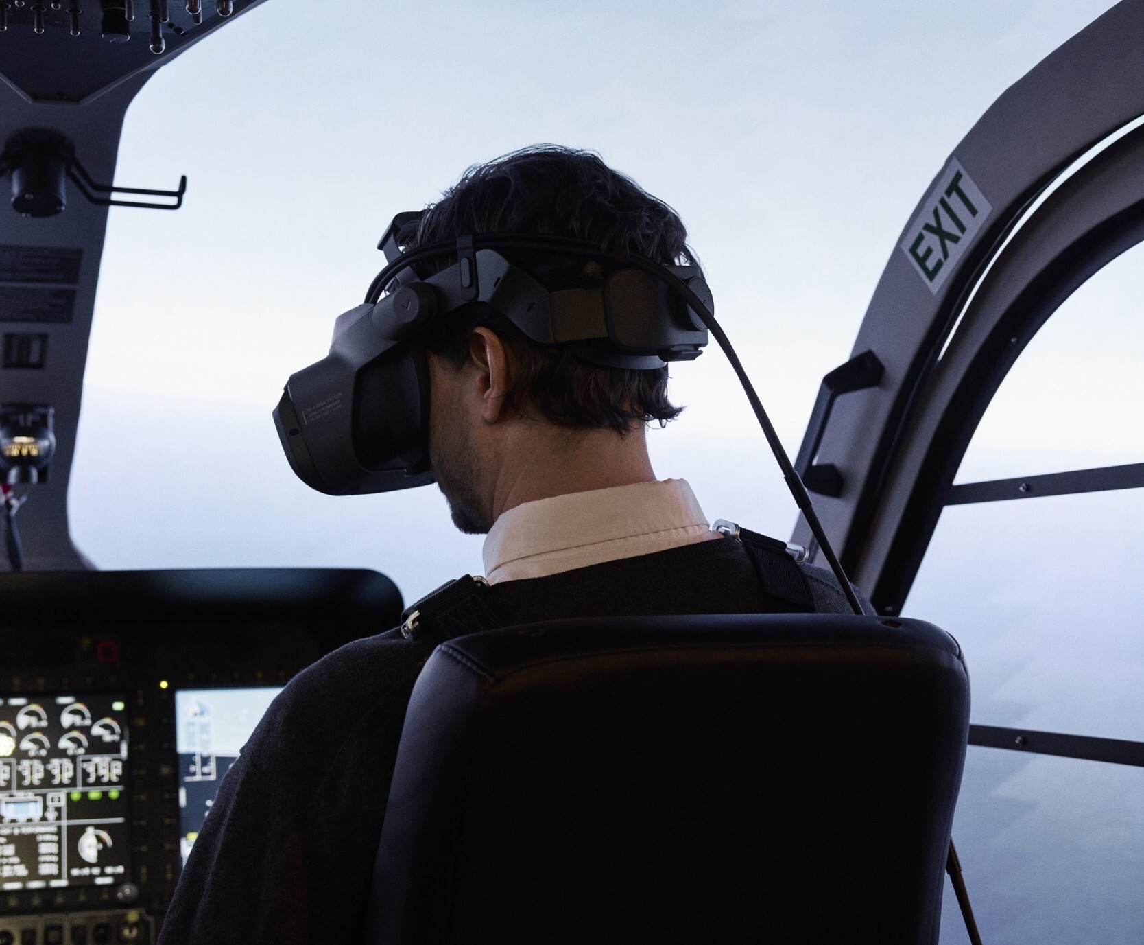 Pilot sitting in a flight simulator wearing a Varjo XR-4 headset