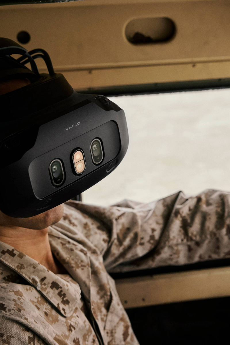 A person wearing an XR headset sitting in a vehicle