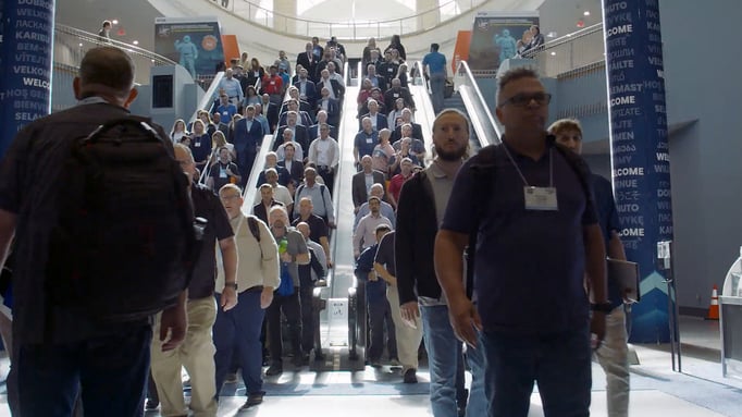 people walking down the stairs at a conference centre