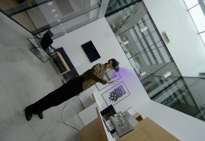 A person standing in an office space, wearing an XR headset