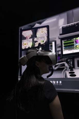 A person wearing a VR headset looking at a medical screen