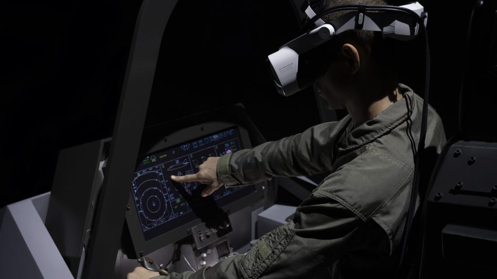 A person sitting in a flight simulator