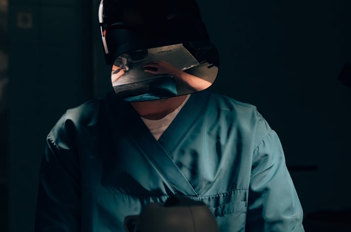 A person in medical scrubs wearing a VR headset