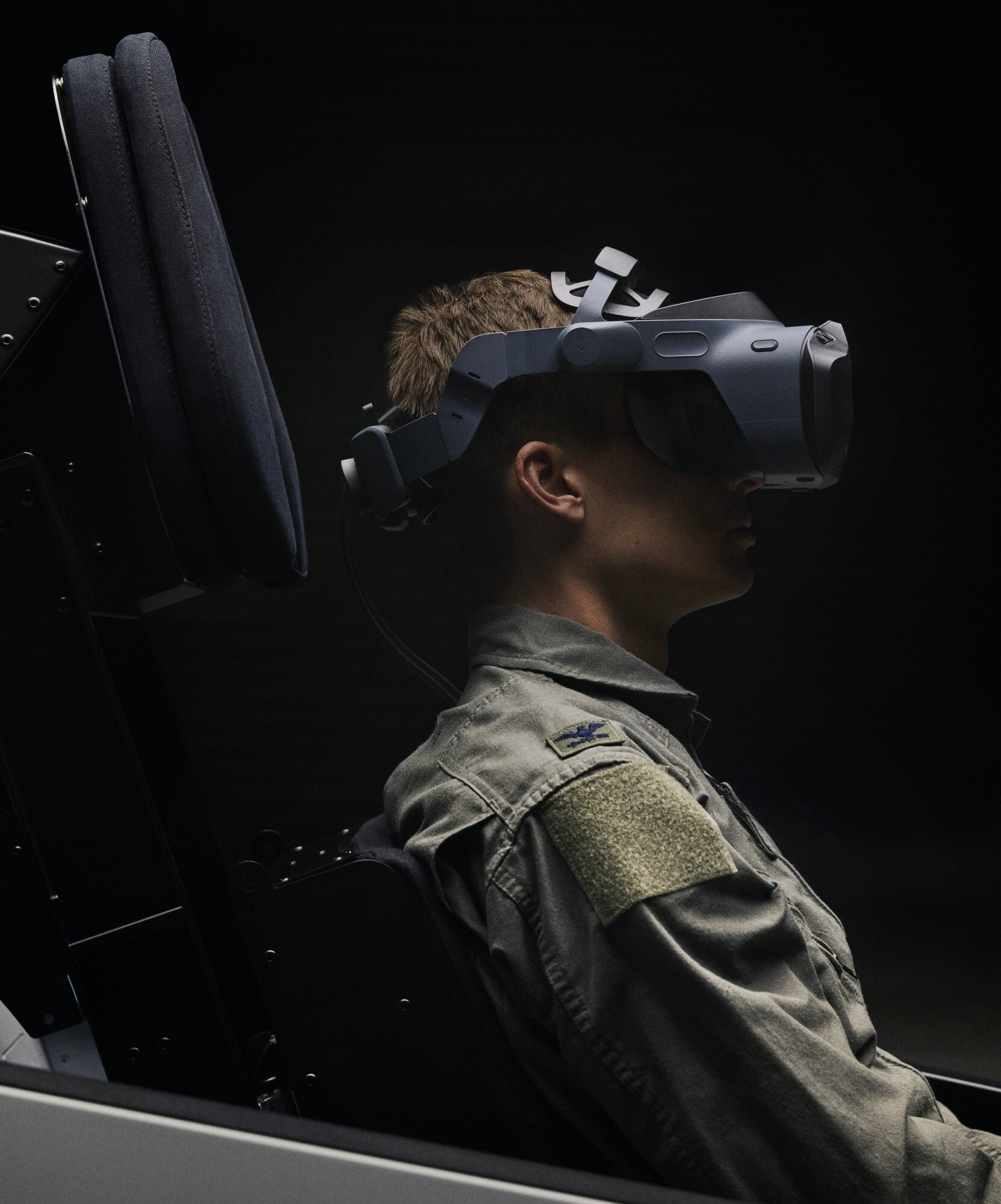 A pilot sitting in a cockpit wearing a Varjo XR-4 Series headset