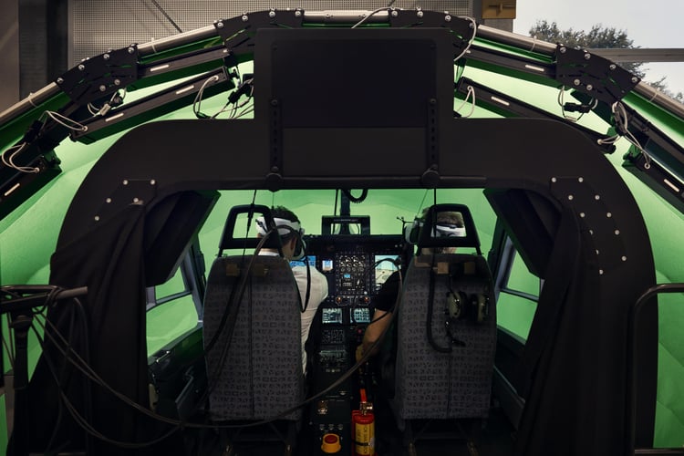 two people sitting in a simulator wearing XR headsets