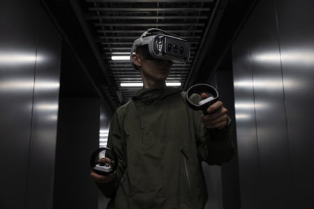 A person standing in a corridor wearing an XR headset